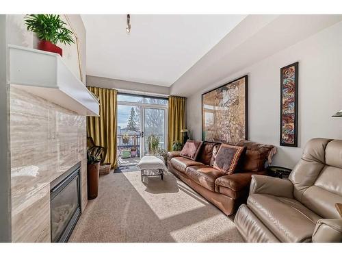 308-518 33 Street Nw, Calgary, AB - Indoor Photo Showing Living Room With Fireplace