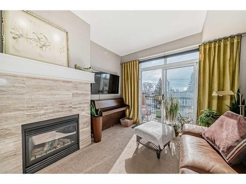 308-518 33 Street Nw, Calgary, AB - Indoor Photo Showing Living Room With Fireplace