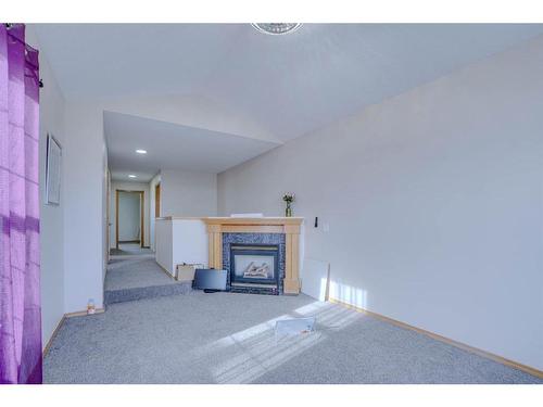 117 Coral Springs Mews Ne, Calgary, AB - Indoor Photo Showing Other Room With Fireplace
