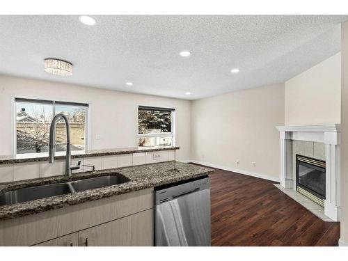 127 Tarington Close Ne, Calgary, AB - Indoor Photo Showing Kitchen With Fireplace With Double Sink