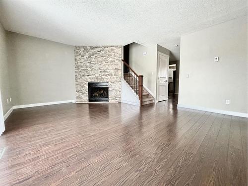 151-7172 Coach Hill Road Sw, Calgary, AB - Indoor Photo Showing Living Room With Fireplace