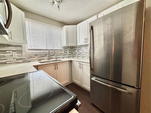 151-7172 Coach Hill Road Sw, Calgary, AB - Indoor Photo Showing Kitchen With Stainless Steel Kitchen With Double Sink