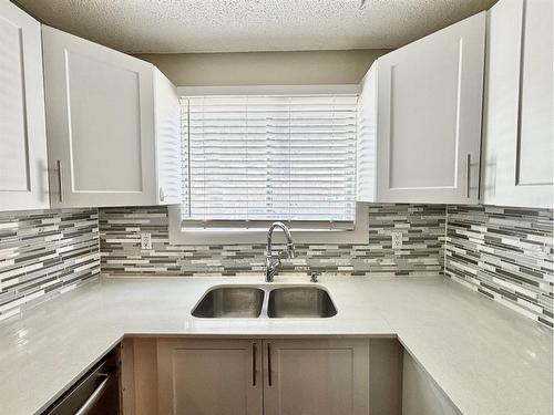 151-7172 Coach Hill Road Sw, Calgary, AB - Indoor Photo Showing Kitchen With Double Sink