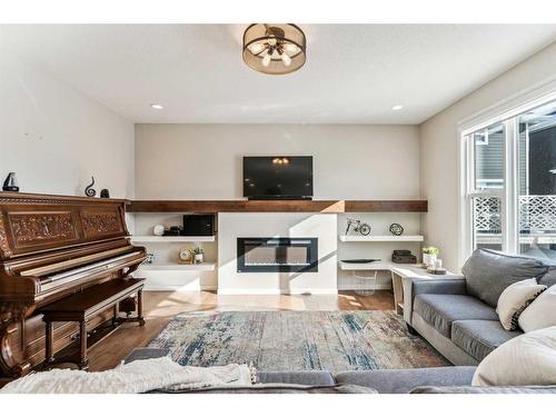 191 West Grove Way Sw, Calgary, AB - Indoor Photo Showing Living Room With Fireplace