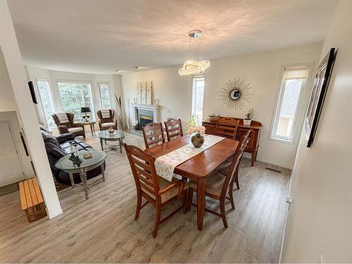 35 West Mitford Crescent, Cochrane, AB - Indoor Photo Showing Dining Room With Fireplace