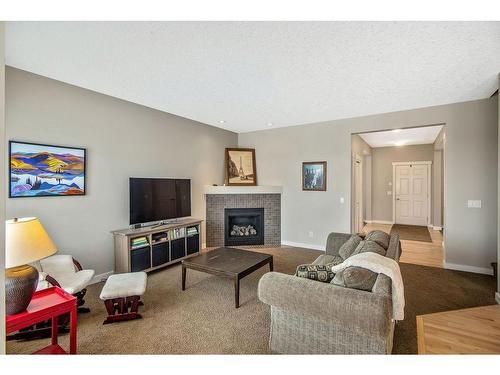 101 Elgin Meadows Circle Se, Calgary, AB - Indoor Photo Showing Living Room With Fireplace