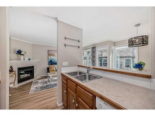 2-95 Grier Place Ne, Calgary, AB - Indoor Photo Showing Kitchen With Fireplace With Double Sink