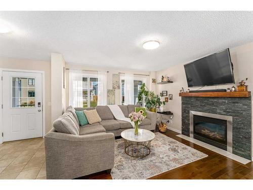 228 Copperpond Parade Se, Calgary, AB - Indoor Photo Showing Living Room With Fireplace