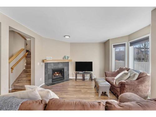 226 Hawkstone Manor Nw, Calgary, AB - Indoor Photo Showing Living Room With Fireplace