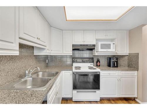 226 Hawkstone Manor Nw, Calgary, AB - Indoor Photo Showing Kitchen With Double Sink