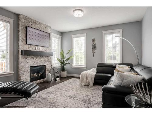 1250 Coopers Drive Sw, Airdrie, AB - Indoor Photo Showing Living Room With Fireplace