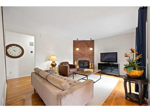 79 Wood Crescent Sw, Calgary, AB - Indoor Photo Showing Living Room With Fireplace