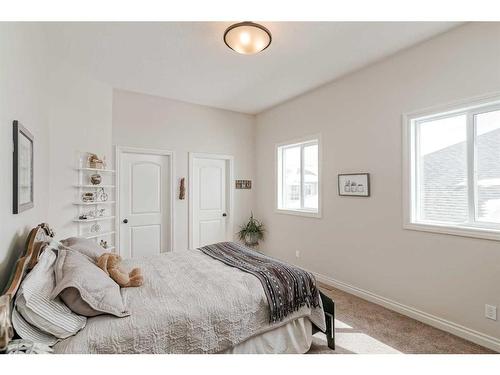 211 Sunset Square, Cochrane, AB - Indoor Photo Showing Bedroom