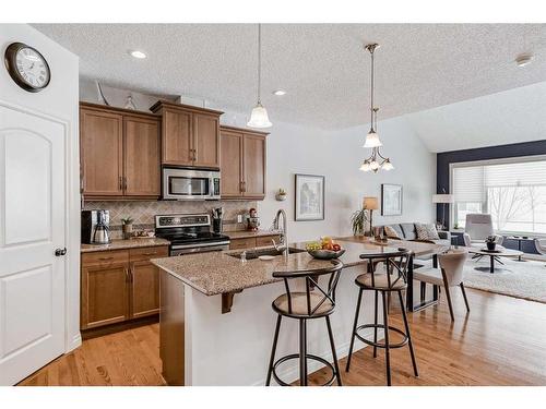 211 Sunset Square, Cochrane, AB - Indoor Photo Showing Kitchen With Double Sink