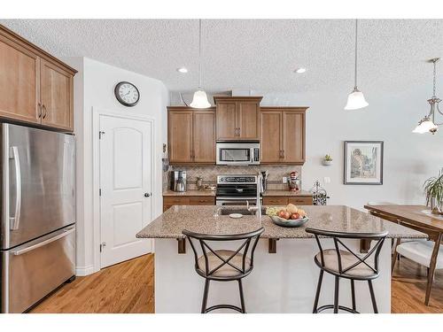 211 Sunset Square, Cochrane, AB - Indoor Photo Showing Kitchen With Stainless Steel Kitchen With Double Sink