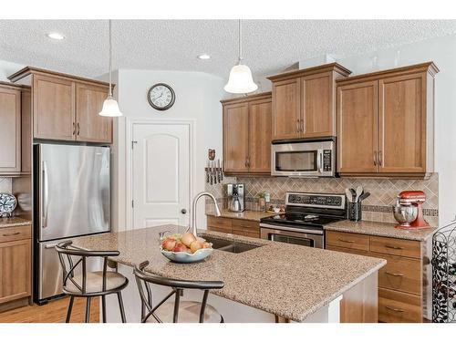 211 Sunset Square, Cochrane, AB - Indoor Photo Showing Kitchen With Stainless Steel Kitchen With Double Sink