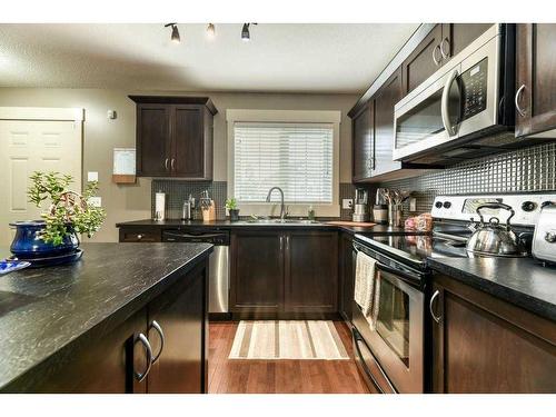 209 Rainbow Falls Manor, Chestermere, AB - Indoor Photo Showing Kitchen With Double Sink