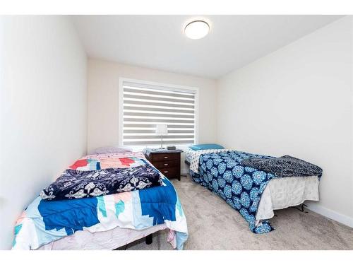 124 Emberside Place, Cochrane, AB - Indoor Photo Showing Bedroom