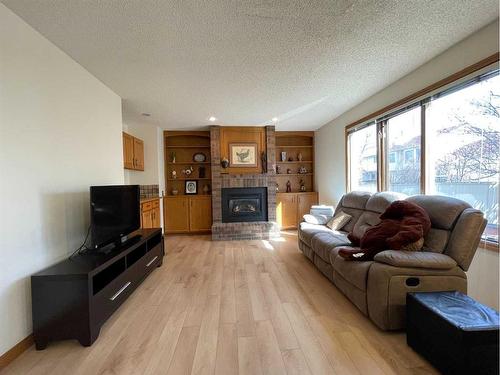 215 Edgebank Place Nw, Calgary, AB - Indoor Photo Showing Living Room With Fireplace