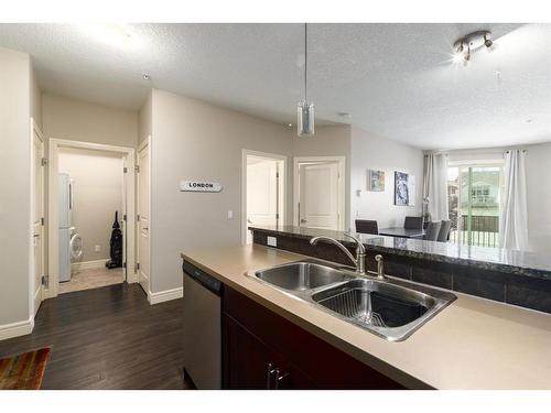 3206-15 Sunset Square, Cochrane, AB - Indoor Photo Showing Kitchen With Double Sink
