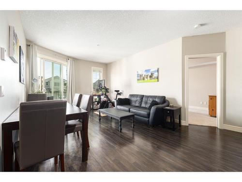 3206-15 Sunset Square, Cochrane, AB - Indoor Photo Showing Living Room