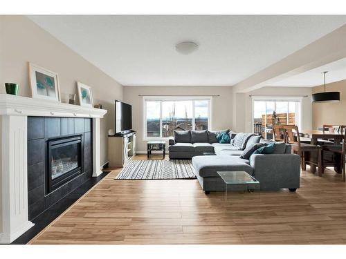233 Sunset Heights, Cochrane, AB - Indoor Photo Showing Living Room With Fireplace