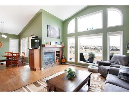 78 Gleneagles Close, Cochrane, AB - Indoor Photo Showing Living Room With Fireplace