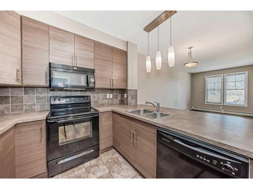 323-207 Sunset Drive, Cochrane, AB - Indoor Photo Showing Kitchen With Double Sink