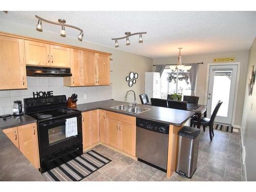 310 Ranch Garden, Strathmore, AB - Indoor Photo Showing Kitchen With Double Sink