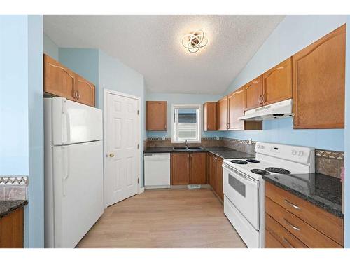 1060 Bridlemeadows Manor Sw, Calgary, AB - Indoor Photo Showing Kitchen With Double Sink