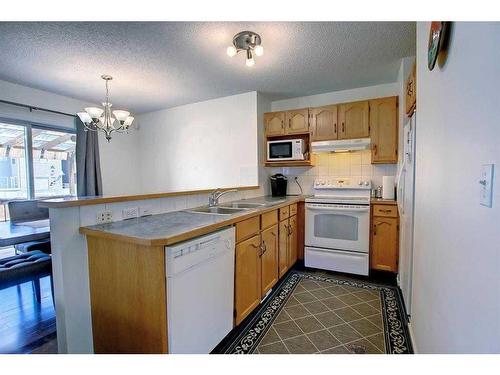 98 Saddleback Road Ne, Calgary, AB - Indoor Photo Showing Kitchen With Double Sink