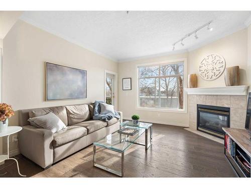 204-60 24 Avenue Sw, Calgary, AB - Indoor Photo Showing Living Room With Fireplace