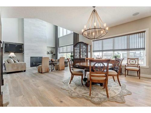 142 Waters Edge Drive, Heritage Pointe, AB - Indoor Photo Showing Dining Room With Fireplace