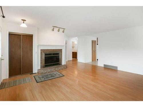 1705 16 Street, Didsbury, AB - Indoor Photo Showing Living Room With Fireplace