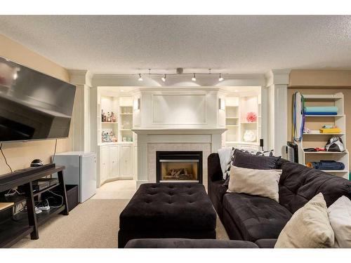 74 Discovery Ridge Road Sw, Calgary, AB - Indoor Photo Showing Living Room With Fireplace