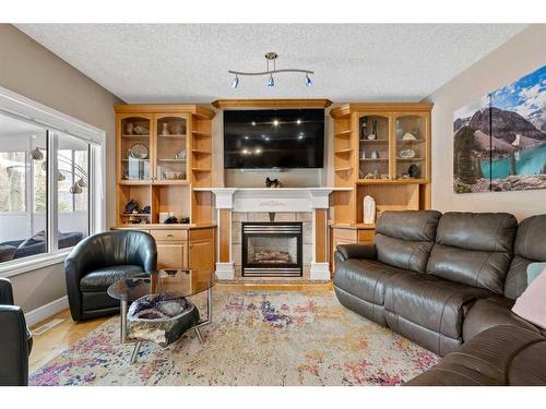 171 Sunterra Ridge Place, Cochrane, AB - Indoor Photo Showing Living Room With Fireplace