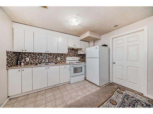 85 Saddlemont Road Ne, Calgary, AB - Indoor Photo Showing Kitchen With Double Sink