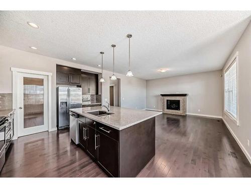 554 Sherwood Boulevard Nw, Calgary, AB - Indoor Photo Showing Kitchen With Fireplace With Upgraded Kitchen