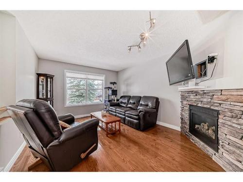163 Eversyde Circle Sw, Calgary, AB - Indoor Photo Showing Living Room With Fireplace