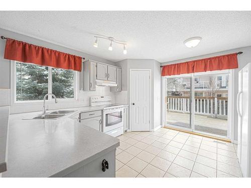 4 West Tower Place, Cochrane, AB - Indoor Photo Showing Kitchen With Double Sink