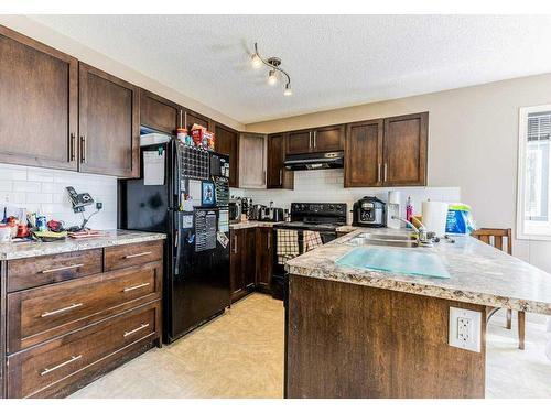 37-105 Drake Landing Common, Okotoks, AB - Indoor Photo Showing Kitchen With Double Sink