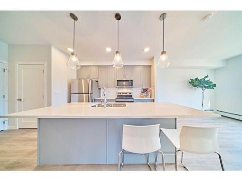 210-200 Shawnee Square Sw, Calgary, AB - Indoor Photo Showing Kitchen With Double Sink With Upgraded Kitchen