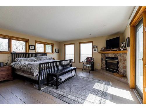 43342 Range Road 183, Rural Camrose County, AB - Indoor Photo Showing Bedroom With Fireplace