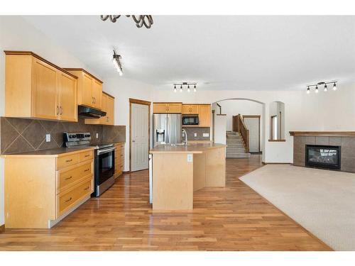 27 Cranfield Circle Se, Calgary, AB - Indoor Photo Showing Kitchen With Fireplace