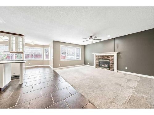 20 Mt Cascade Close Se, Calgary, AB - Indoor Photo Showing Other Room With Fireplace