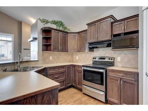 9 Cimarron Grove Drive, Okotoks, AB - Indoor Photo Showing Kitchen With Double Sink