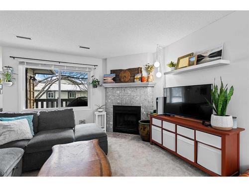 123 Cedar Springs Gardens Sw, Calgary, AB - Indoor Photo Showing Living Room With Fireplace