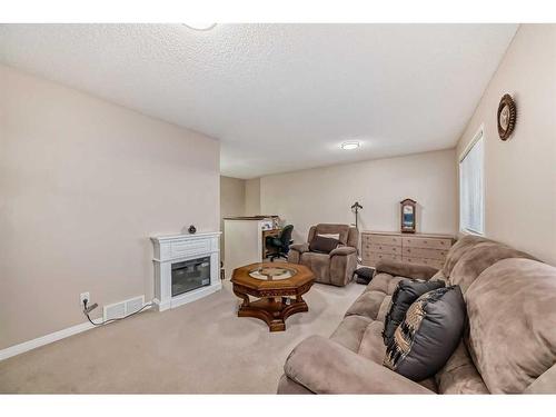 15 Everwoods Green Sw, Calgary, AB - Indoor Photo Showing Living Room With Fireplace