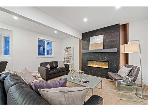 438 Rocky Ridge Cove Nw, Calgary, AB - Indoor Photo Showing Living Room With Fireplace