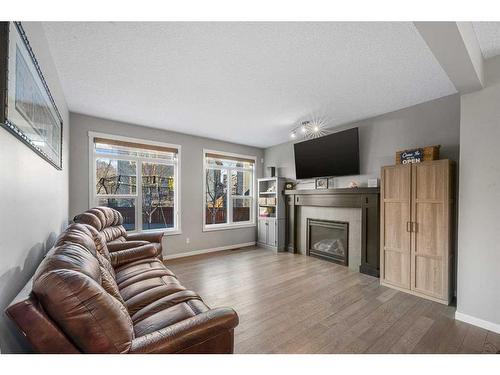 91 Cranbrook Place Se, Calgary, AB - Indoor Photo Showing Living Room With Fireplace